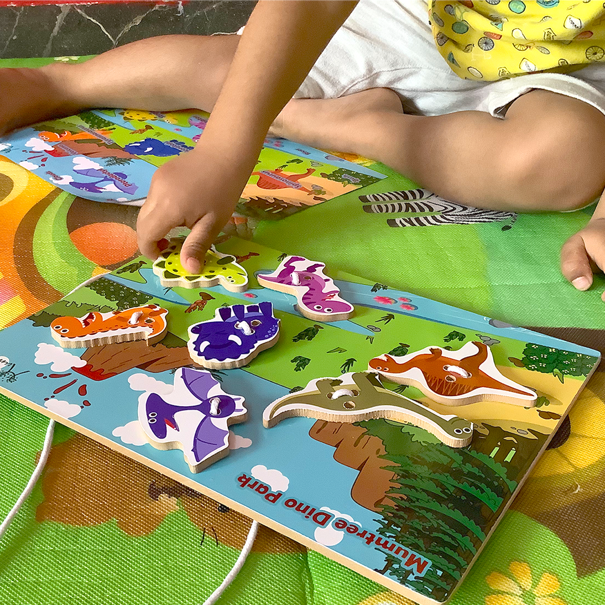 Mumtree Dino Park Sew Habitat image : Includes a kid is sewing the animal figure on the Wooden sew board with lace.